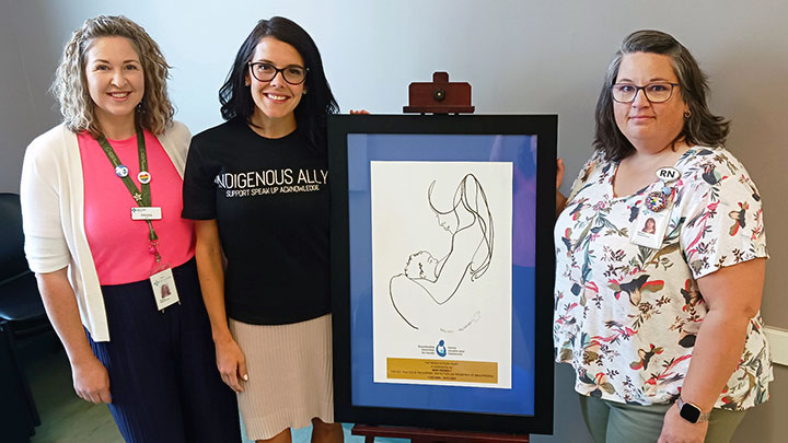 Fort McMurray Public Health team members Melissa Crozier, left, Kathi Lee Volk and Danelle Mandeville show their Baby-Friendly designation plaque. -image via AHS media release